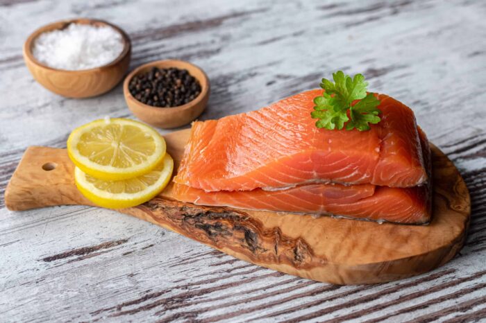 smoked salmon on wooden platter with lemon